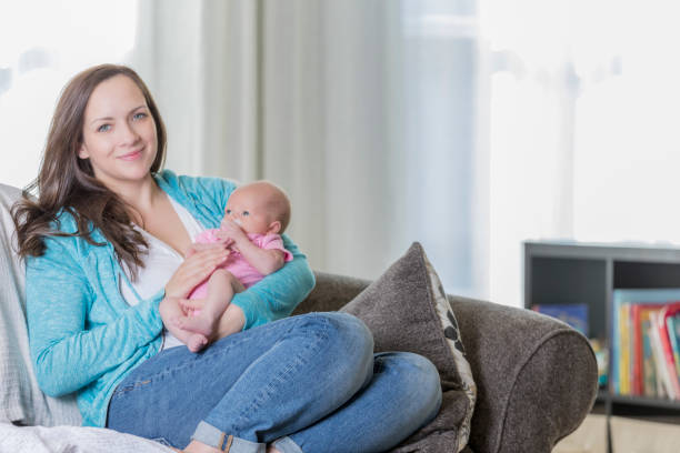 istock Proud mom holds her infant daughter 646136014