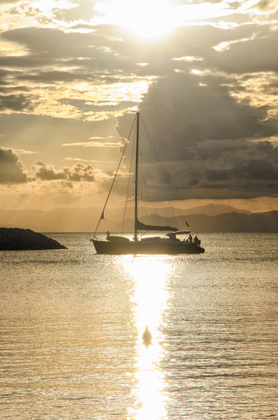 istock Sailing boat crossing the sun glitter 646141816