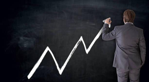 Business man writes index on blackboard concept