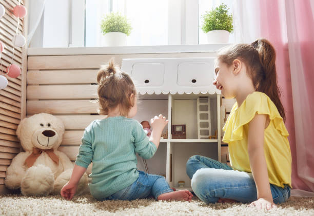 istock girls play with doll house 646151148