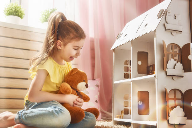 istock girl plays with doll house 646151244