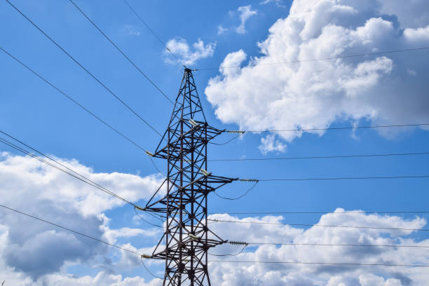 istock Supports high-voltage power lines against the blue sky with clouds. Electrical industry 646155528