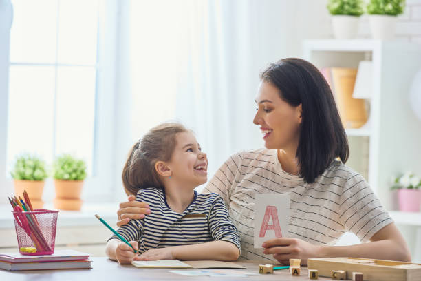 istock woman teaches child the alphabet 646158074