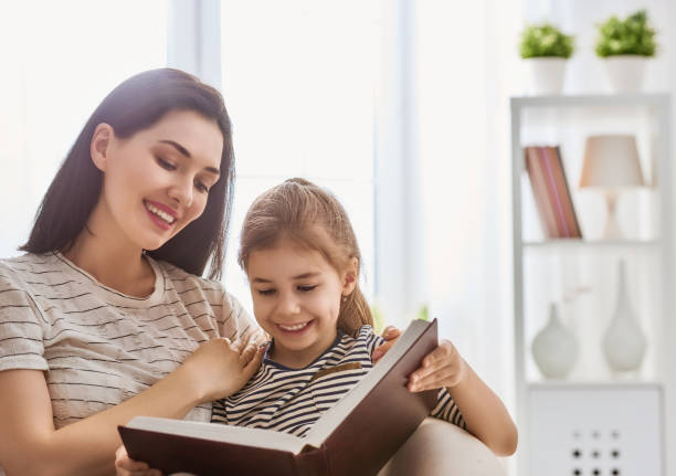 istock Mom and child reading a book 646158080