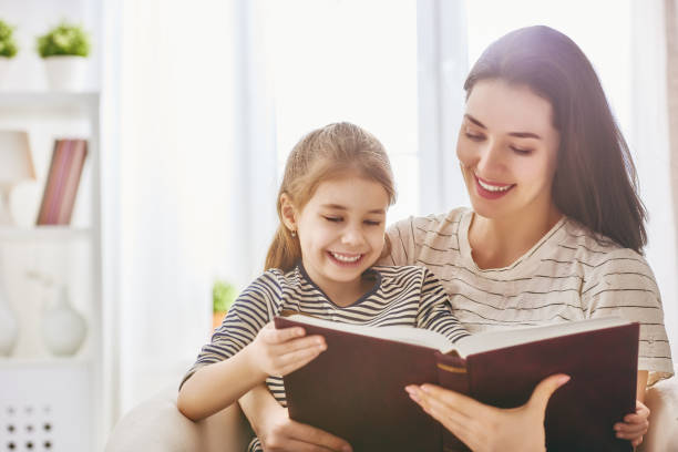 istock Mom and child reading a book 646158098