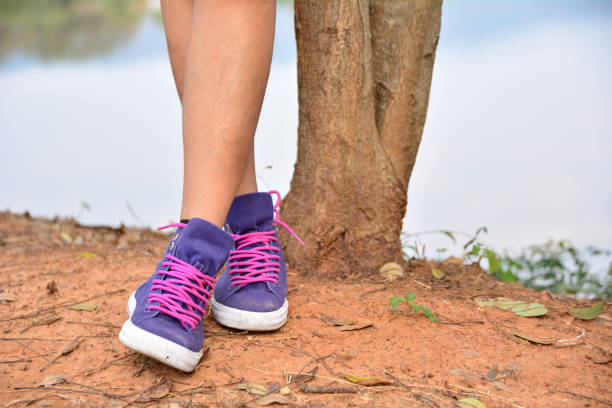 leg of person standing beside tree