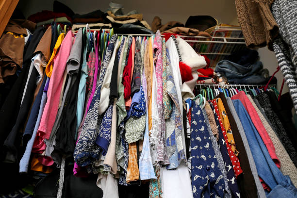 Messy Women's Closet Filled with Colorful Clothes stock photo