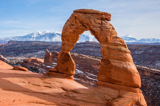 View of Delicate Arch with the La Sal Mountains in the background. Arches National Park. American Southwest.