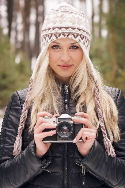 istock Young attractive woman with an old camera 646169198