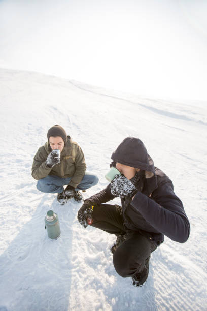 istock Man pouring a drink from a thermos 646169718