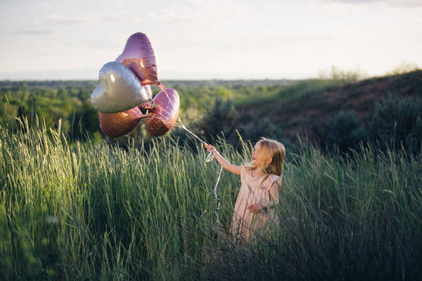 istock Toddler with heart-shaped balloons 646169852