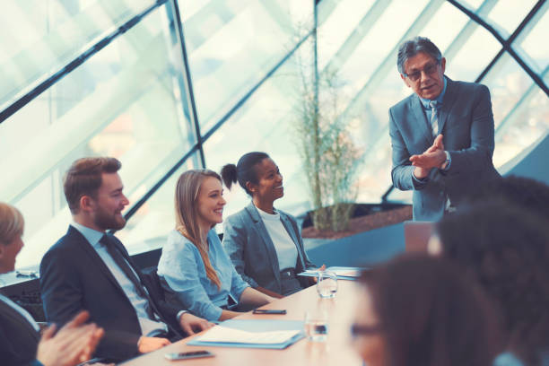 istock Businessman congratulating at the office meeting 646178968