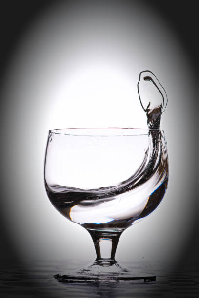 istock Water splash in glass, silver grey background. 646179622