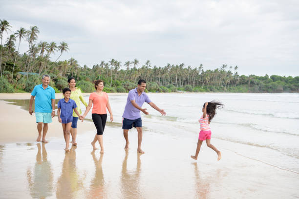 istock Multi generation family having fun together on beach 646182284
