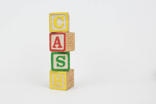 The Word Cash in Wooden Childrens Blocks stock photo