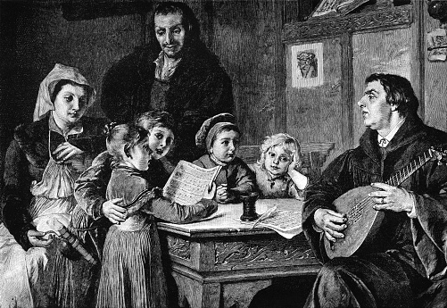 Martin Luther playing the lute to his children. Martin Luther was a professor of theology, musician, composer, hymnodist, priest and monk who was a major influence in the Protestant Reformation.  From “A Gift For a Pet” by Annie R. Butler. Published in London by The Religious Tract Society, 1896.