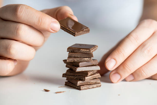 istock Mixed race woman stacking chocolate 646190006