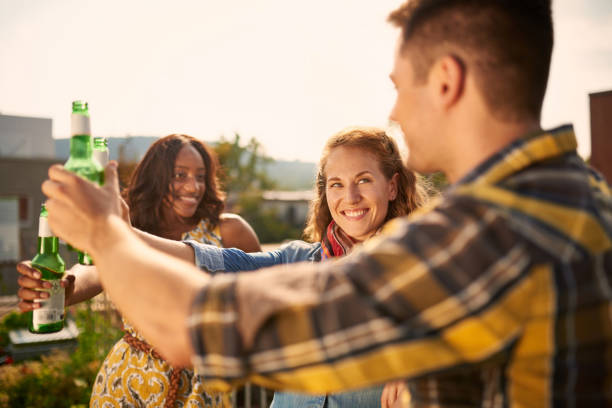 istock Group of friends making a toast with beef on a rooftop 646190628