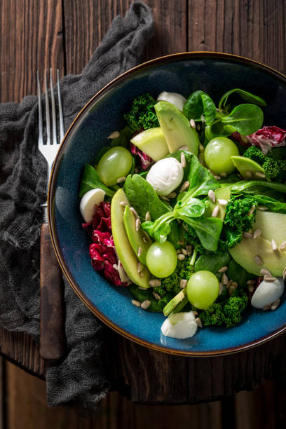 istock Spring kale salad with mix of vegetables and avocado 646196780