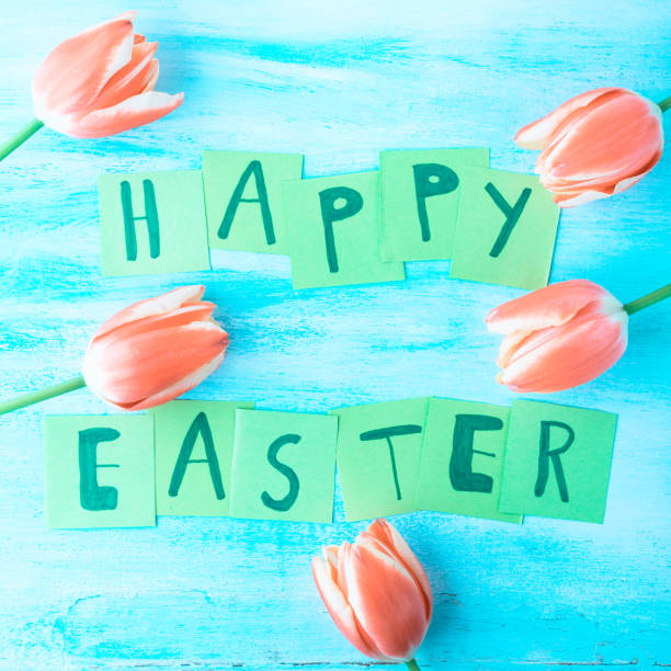 istock Happy Easter background tulips flowers hand written letters 646200672