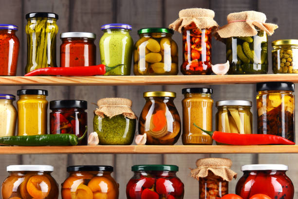 Jars with variety of pickled vegetables. Jars with variety of pickled vegetables. Preserved food preserved stock pictures, royalty-free photos & images