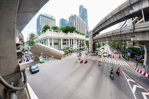 Bangkok, Thailand – September 25, 2016: A surveillance camera looking over Ratchaprasong Junction. Showing traffic and the BTS elevated railway. The Erawan Shrine, formally known as the Thao Maha Phrom Shrine, is visible in the background, with tourist and worshipers in attendence.