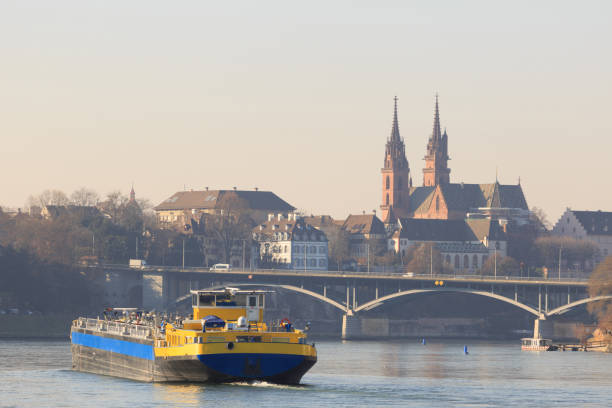 An anonymous cargo ship in front of the Basel Cathedral on the Rhine in Basel, Switzerland. An anonymous cargo ship in front of the Basel Cathedral on the Rhine in Basel, Switzerland.