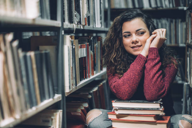 istock Worried student thinking of her upcoming exams in a library. 646213588