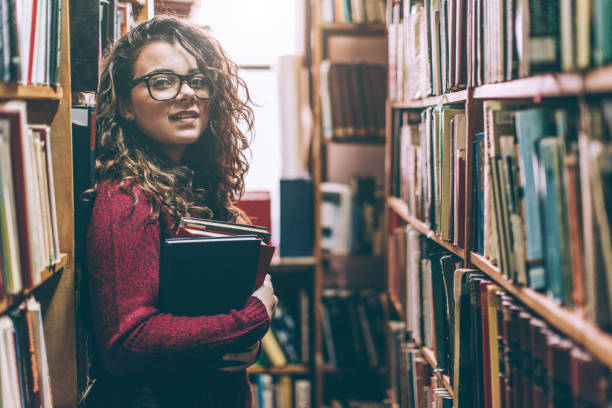 istock Pretty high school or college student in library 646214196