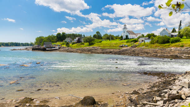 The rural community of South Thomaston as seen across the Weskeag River on a summer day.
