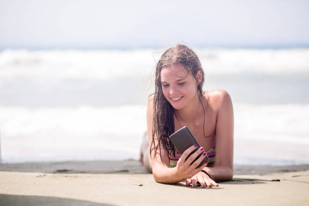 istock beautiful girl taking selfie on a beach 646217902