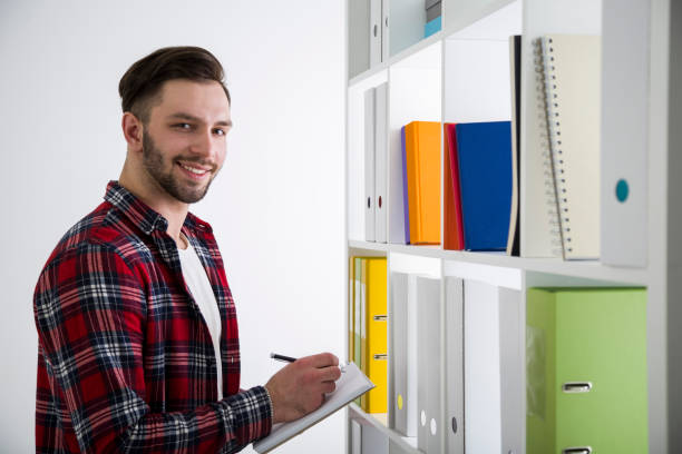 istock Side view of a cheerful man in a library 646218728