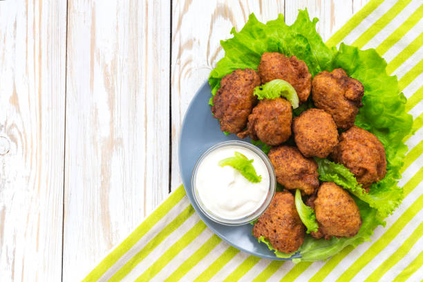 istock Acaraje or akara snack with green salad and sour cream 646228192