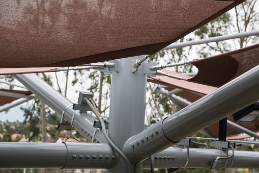 A photograph of a canopy structure posts and covers.