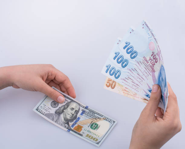 istock Hands holding American dollar and Turksh Lira banknotes 646231328
