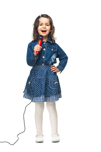 Little Girl singing with microphone isolated on white background