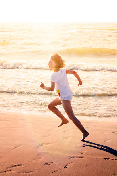 Happy Girl Beach Run Happy girl running along beach smiling. baltic sea photos stock pictures, royalty-free photos & images