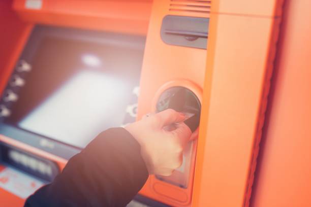 istock Woman slides a credit card 646232320