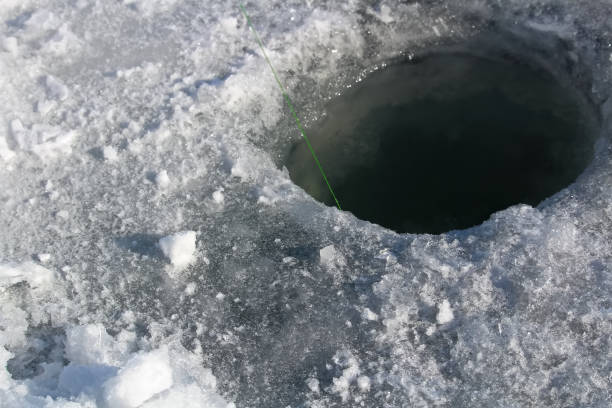 istock Freshly Cleaned Ice Fishing Hole Ready to Set 646234942