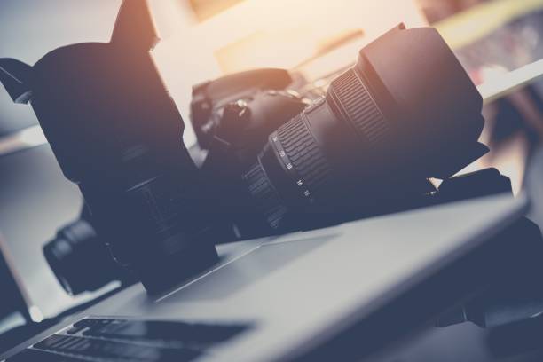 istock Photo Business Equipment. Modern Computer, Digital Camera and Professional Prime Lenses. Doing Photography For a Living Concept.. 646235032