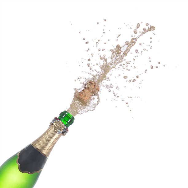 istock bottle of champagne popping its cork and splashing 646235296