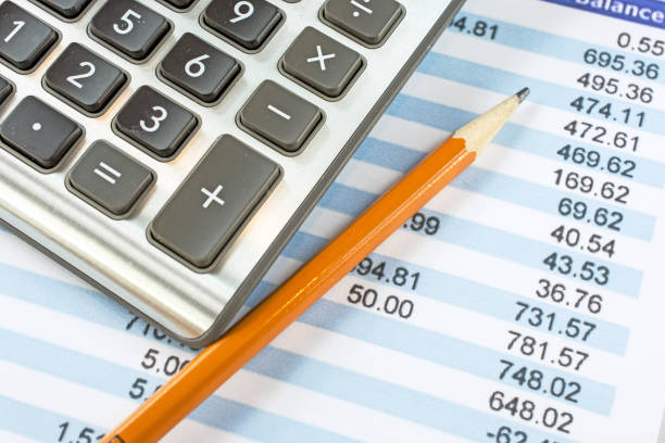 istock Balancing a bank statement close-up with pencil and calculator 646235654
