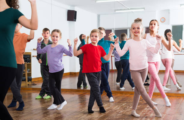 children studying contemp dance group of boys and girls studying contemp dance in studio dance studio instructor stock pictures, royalty-free photos & images