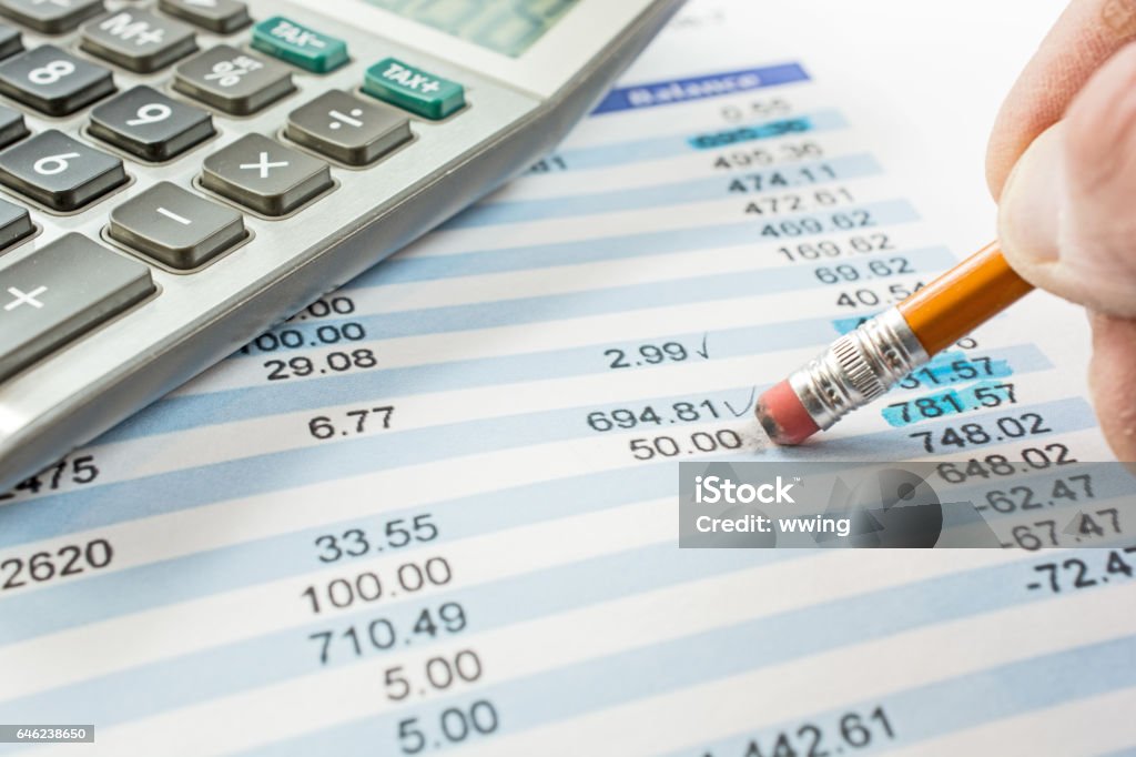 Balancing a bank statement close-up with pencil and calculator Bank Statement Stock Photo