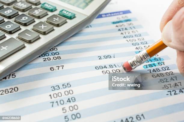 Balancing A Bank Statement Closeup With Pencil And Calculator Stock Photo - Download Image Now