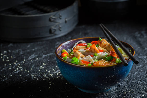 istock Tasty noodle in dark bowl with chopsticks 646238762