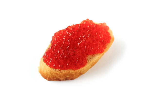 Bread and salmon caviar isolated on white