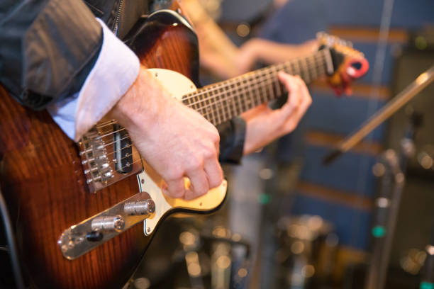 blurred bass guitar player on stage