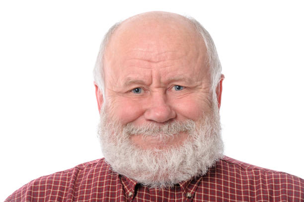 Headshot of cheerful and calm handsome bald and bearded senior man, isolated on white background