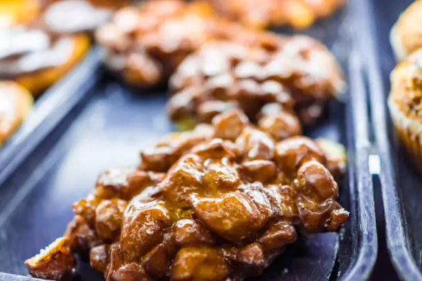 Closeup of golden apple fritter on display